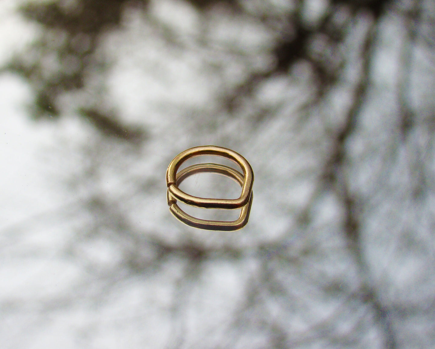 Gold septum piercing