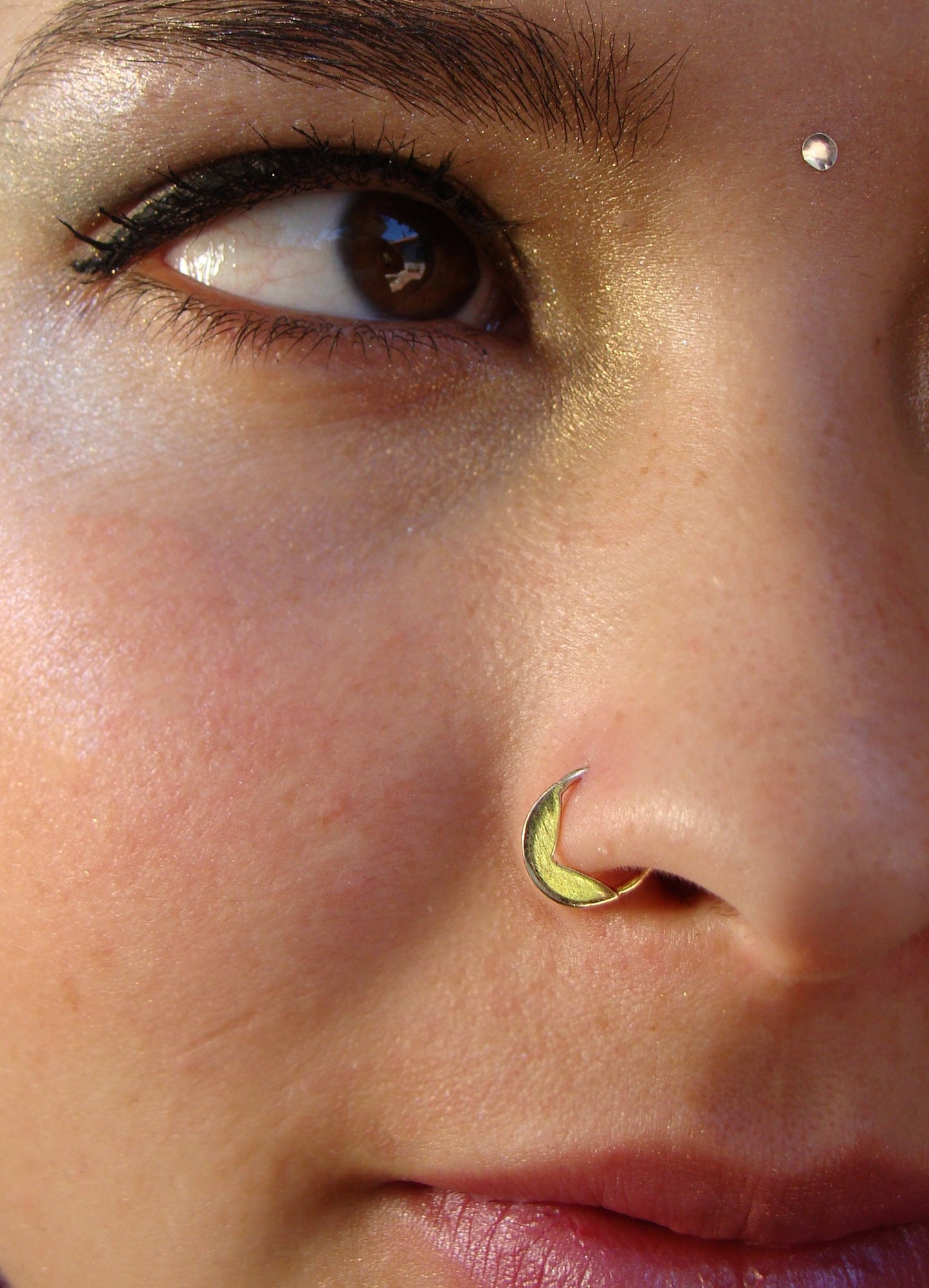 Gold tribal piercing