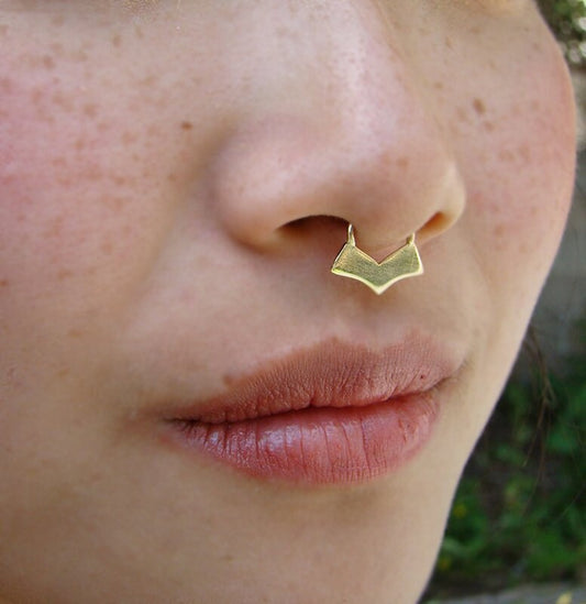 Gold tribal septum piercing