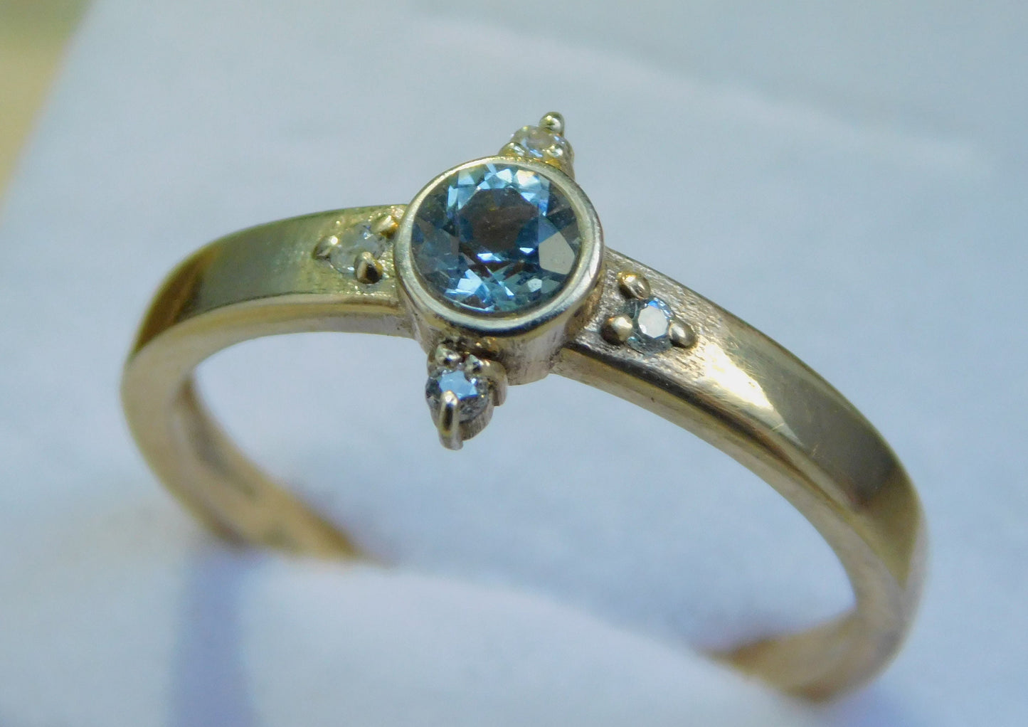 Gold Engagement ring with dark Blue Topaz and diamonds