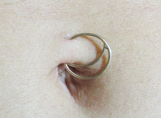 Gold belly piercing